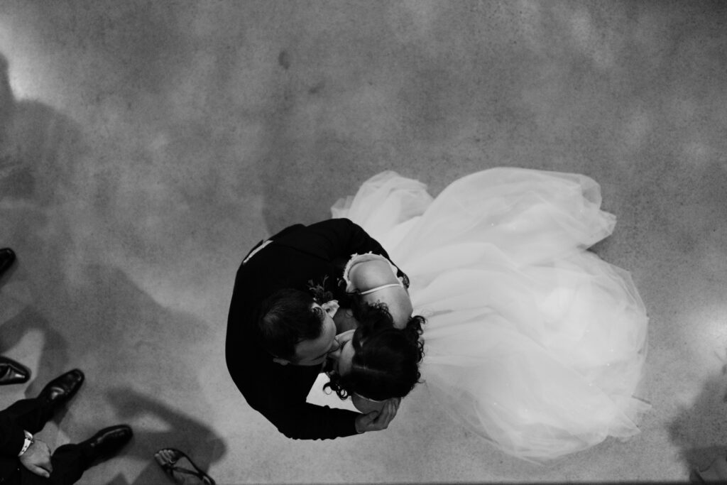 First kiss during wedding ceremony at Tapestry Hall 
