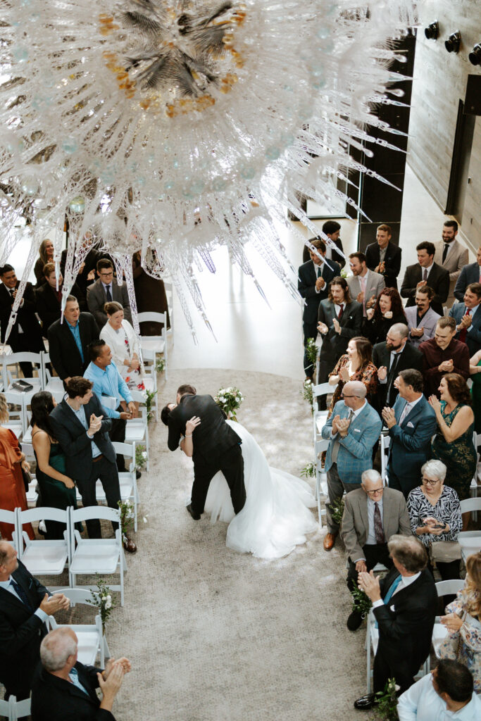 first kiss wedding photo during ceremony at Tapestry Hall