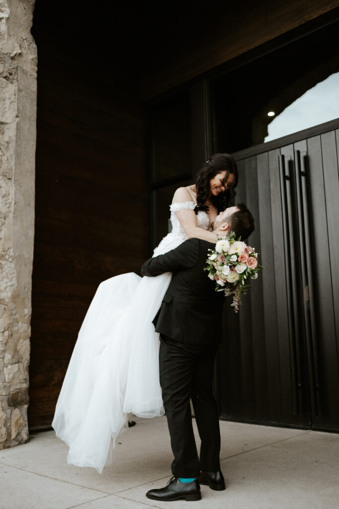 wedding portraits in front of entrance at Tapestry Hall