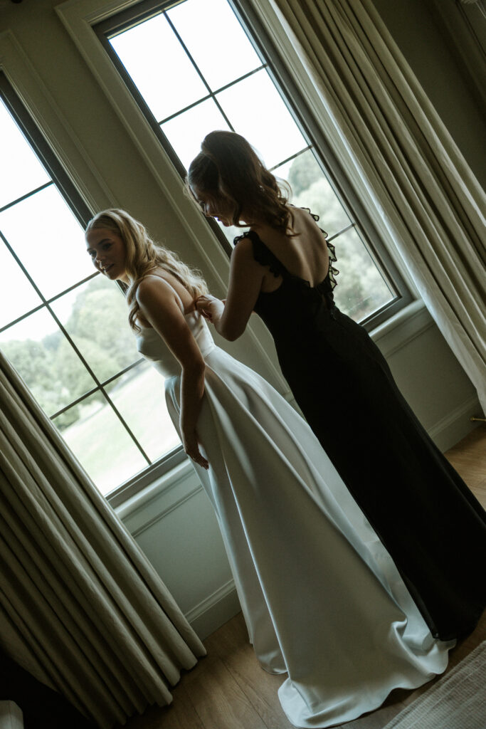 bride getting into dress photo by hematite images